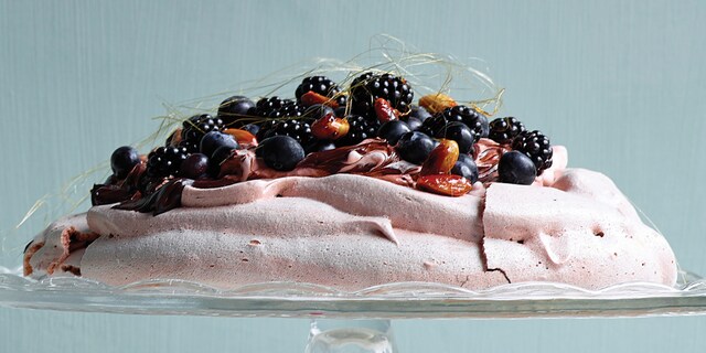 Pavlova met pure chocolade, gekarameliseerde amandelen, bramen en blauwe bosbessen
