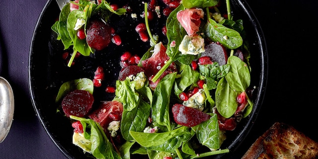 Salade met granaatappel, stiltonkaas, spinazie en Ibericoham