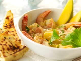 Cassolettes de scampis, sauce crémeuse aux mangues et au coco