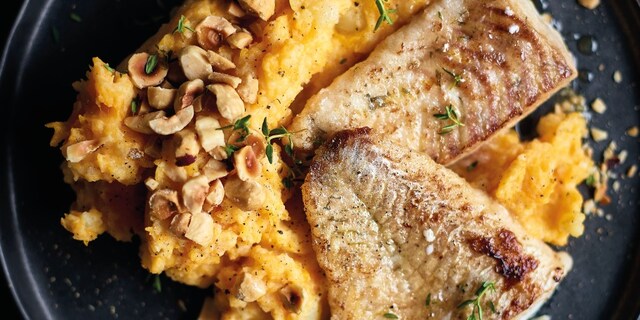 Filets van in de pan gebakken snoekbaars, stoemp van pompoen en hazelnoten 
