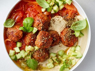 Haver-gehaktballetjes met tomatensaus, romige hummus en komkommersalade