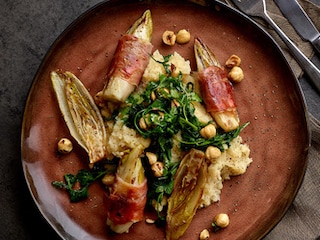 Witloofrolletjes met rauwe ham, knolselderpuree en hazelnoten