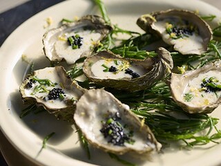 Gerookte oesters op de barbecue met sjalot-dragon saus