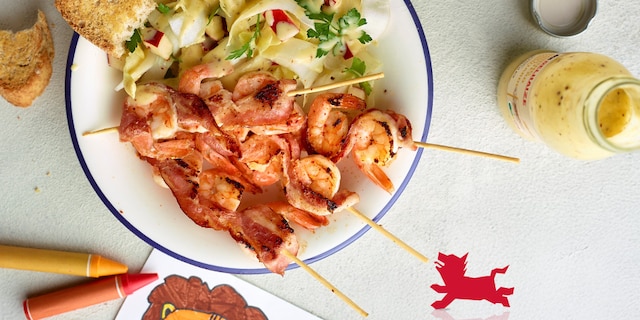 Brochettes de crevettes au lard, salade de chicons aux pommes