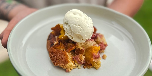 Cobbler met perziken en aardbeien op de barbecue